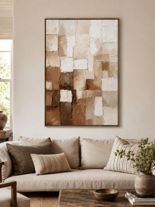 Beige, cream and brown mosaic-like blocks above a pale sofa