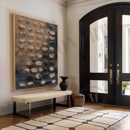 Rounded beige and charcoal pebble-like forms above an entryway bench