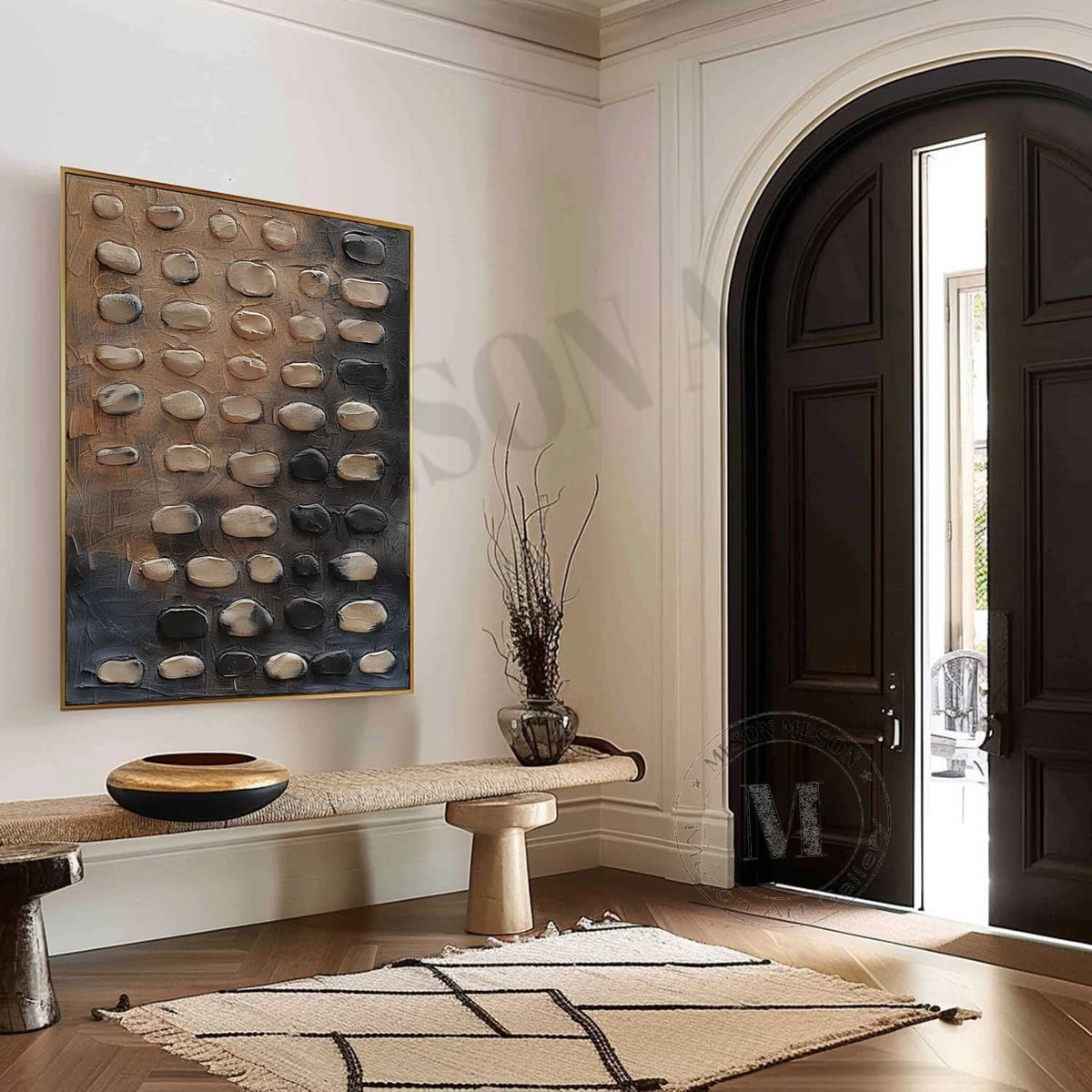 Rounded beige and charcoal pebble-like forms above a wooden console