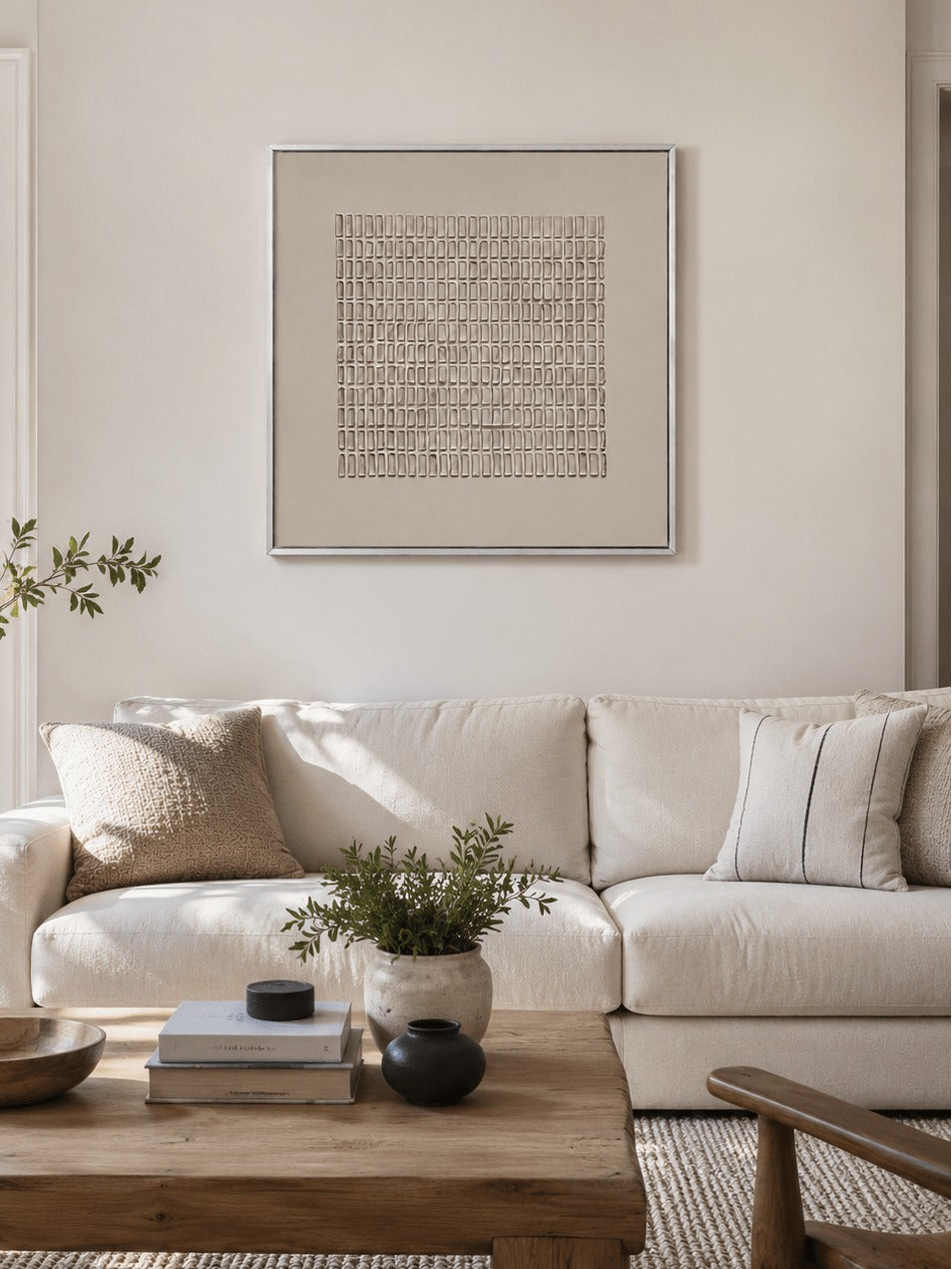 A fine beige geometric grid within a pale border above a pale sofa