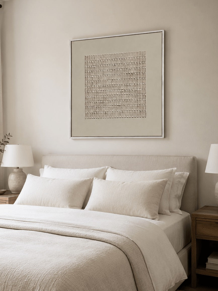 A fine beige geometric grid within a pale border above a bed