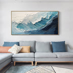 A crashing blue wave with broad white foam above a light blue sofa