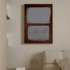Two blue gray fields within a burgundy border above a pale sofa