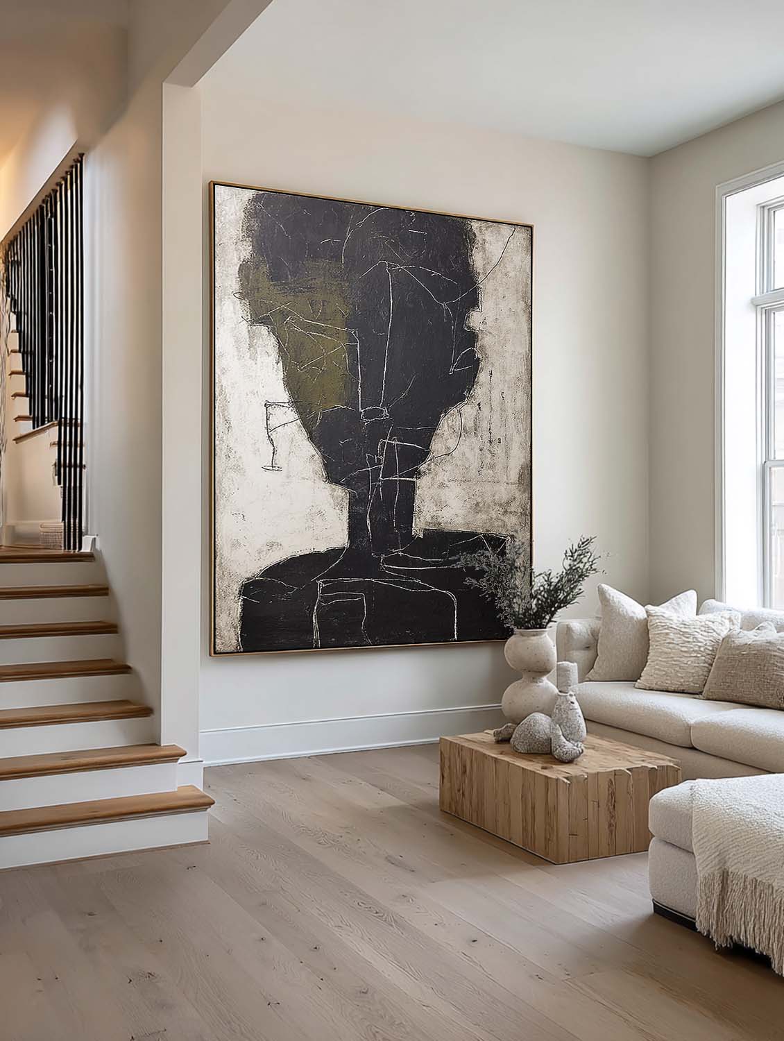 An abstract charcoal face outline with an olive accent beside a staircase
