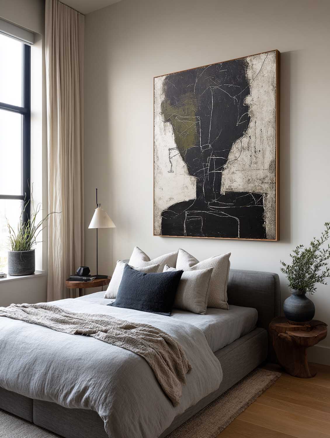 An abstract charcoal face outline with an olive accent above a bed