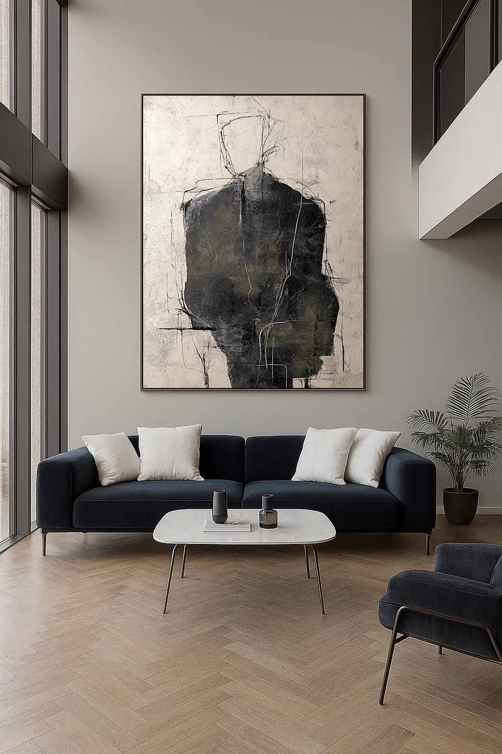 A charcoal figure with a fine outlined head on beige above a dark sofa