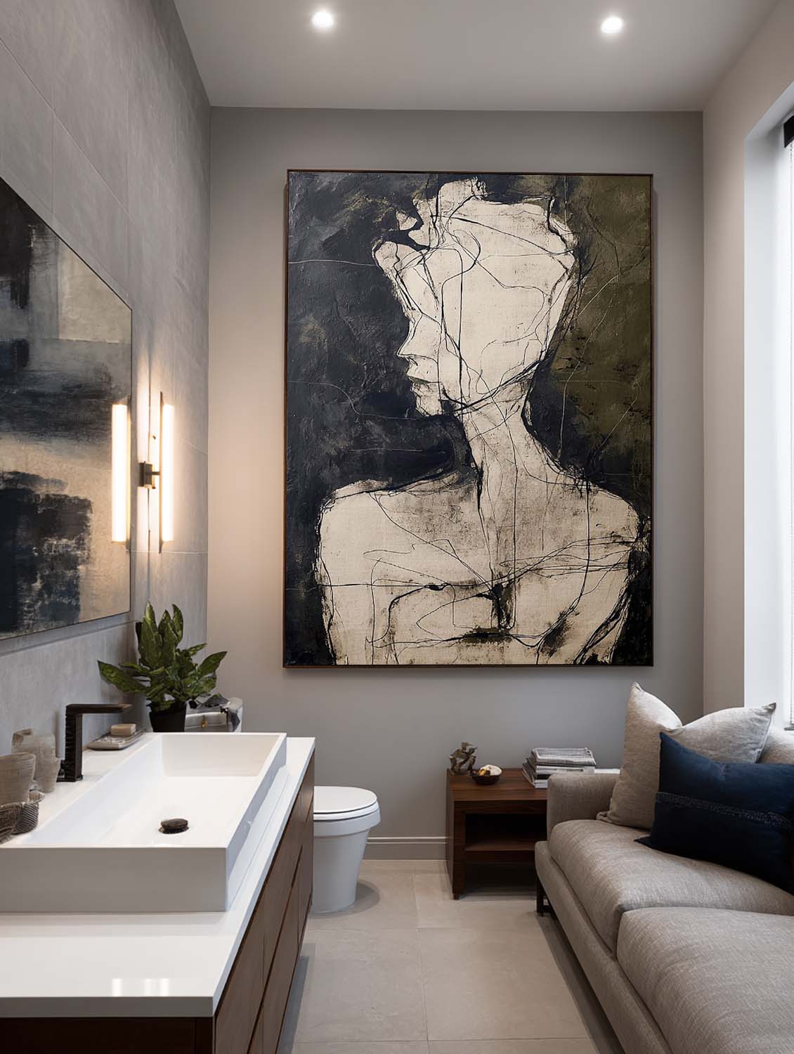 A pale abstract head and shoulders on charcoal above a sofa