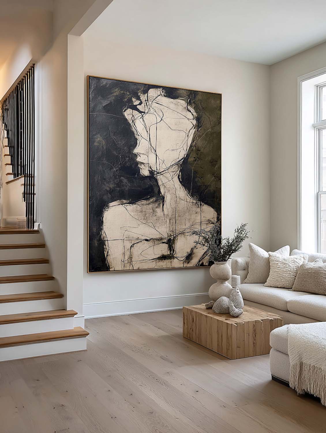 A pale abstract head and shoulders on charcoal beside a staircase