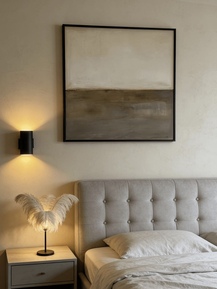 Earth-tone horizon wall art above a bed