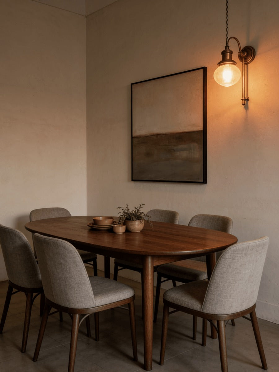 Earth-tone wall art beside a round dining table