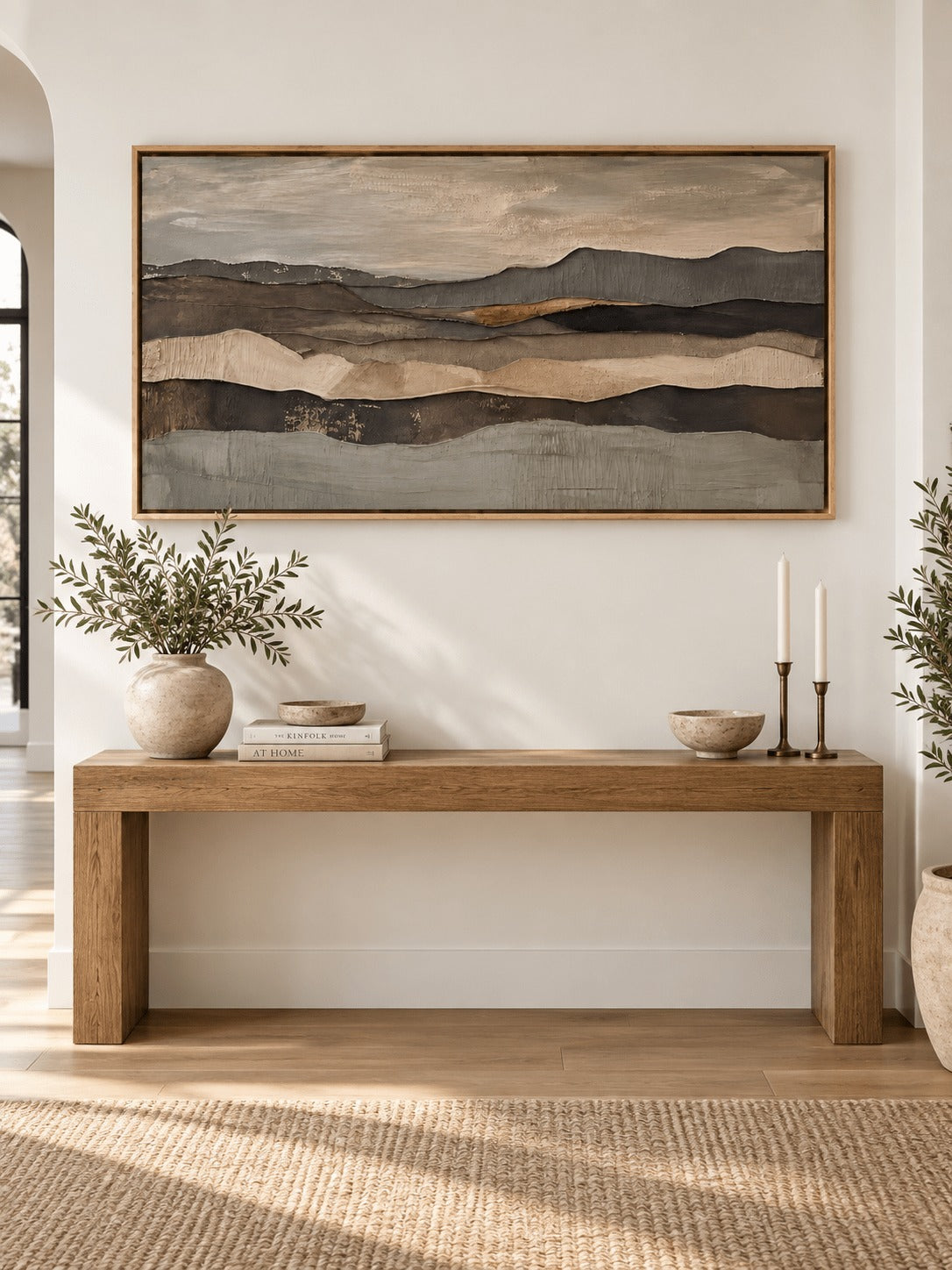 Layered earth tone ridges across a neutral horizon above a wooden console