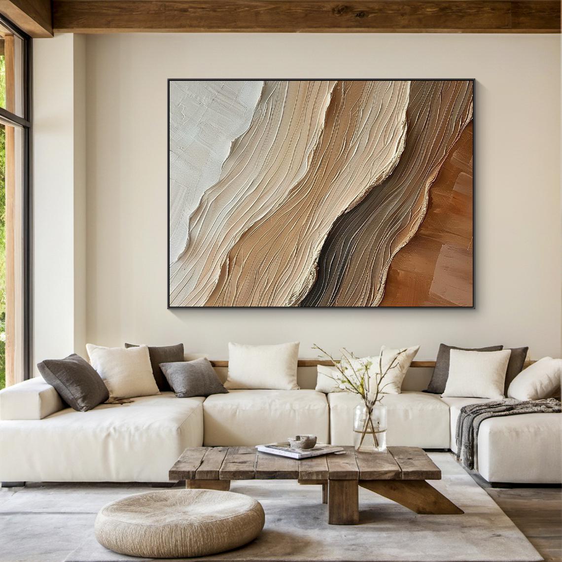 Layered cream, taupe and brown abstract waves above a pale sofa