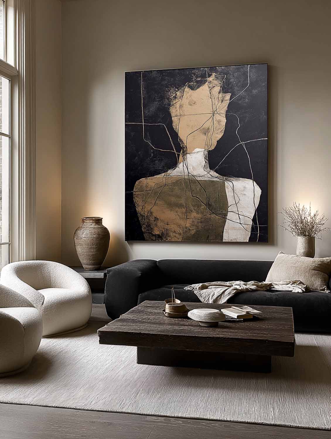 Tall abstract figure canvas above a dark sofa