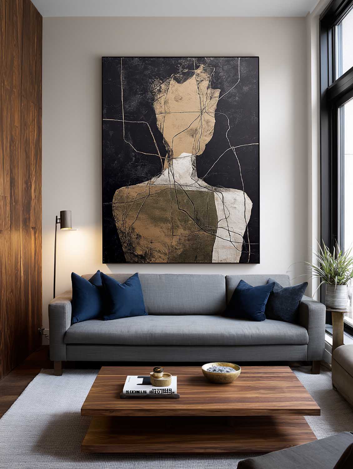 Abstract portrait wall art above a blue sofa