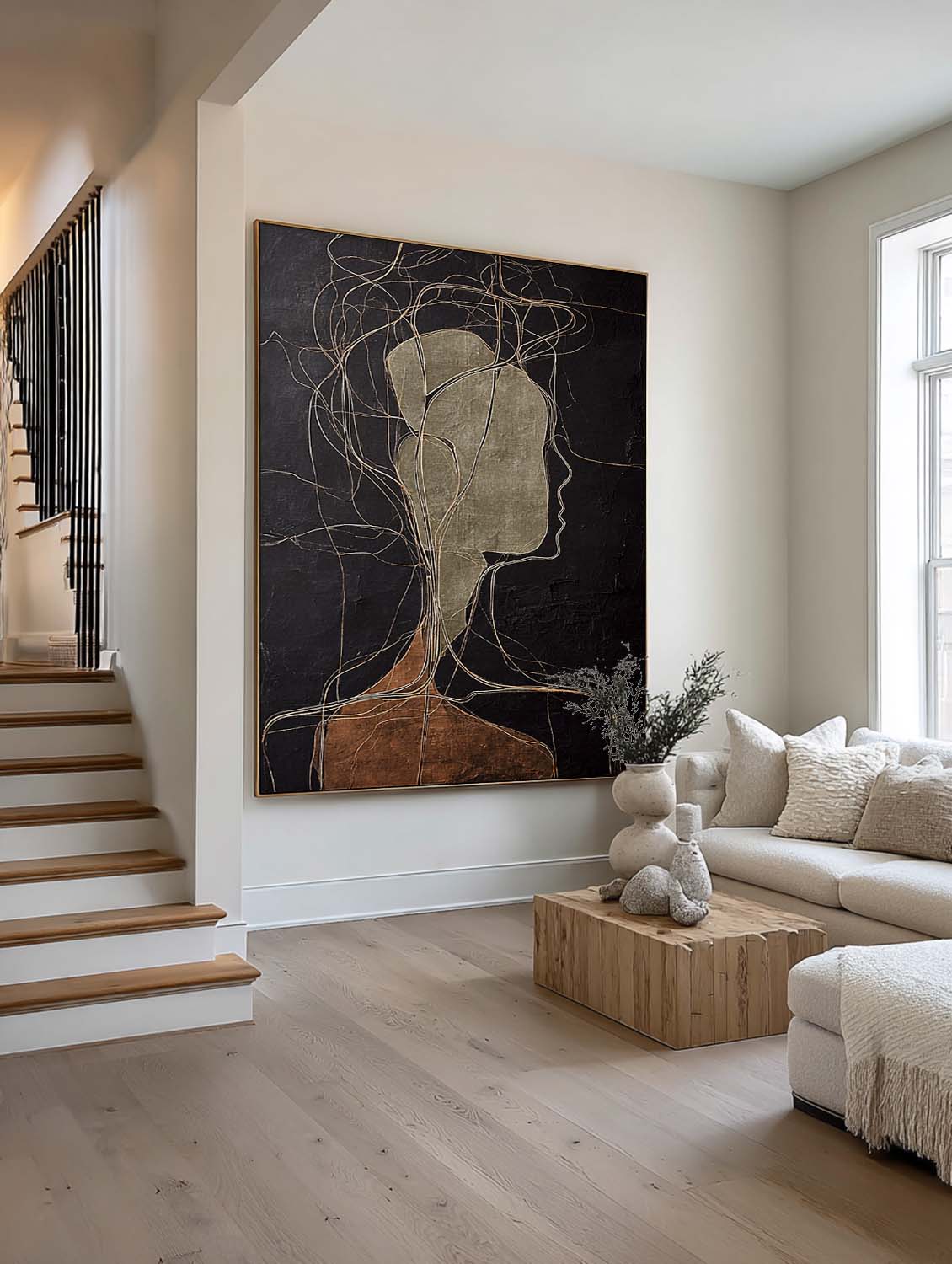 A pale abstract side profile with looping lines on black beside a staircase