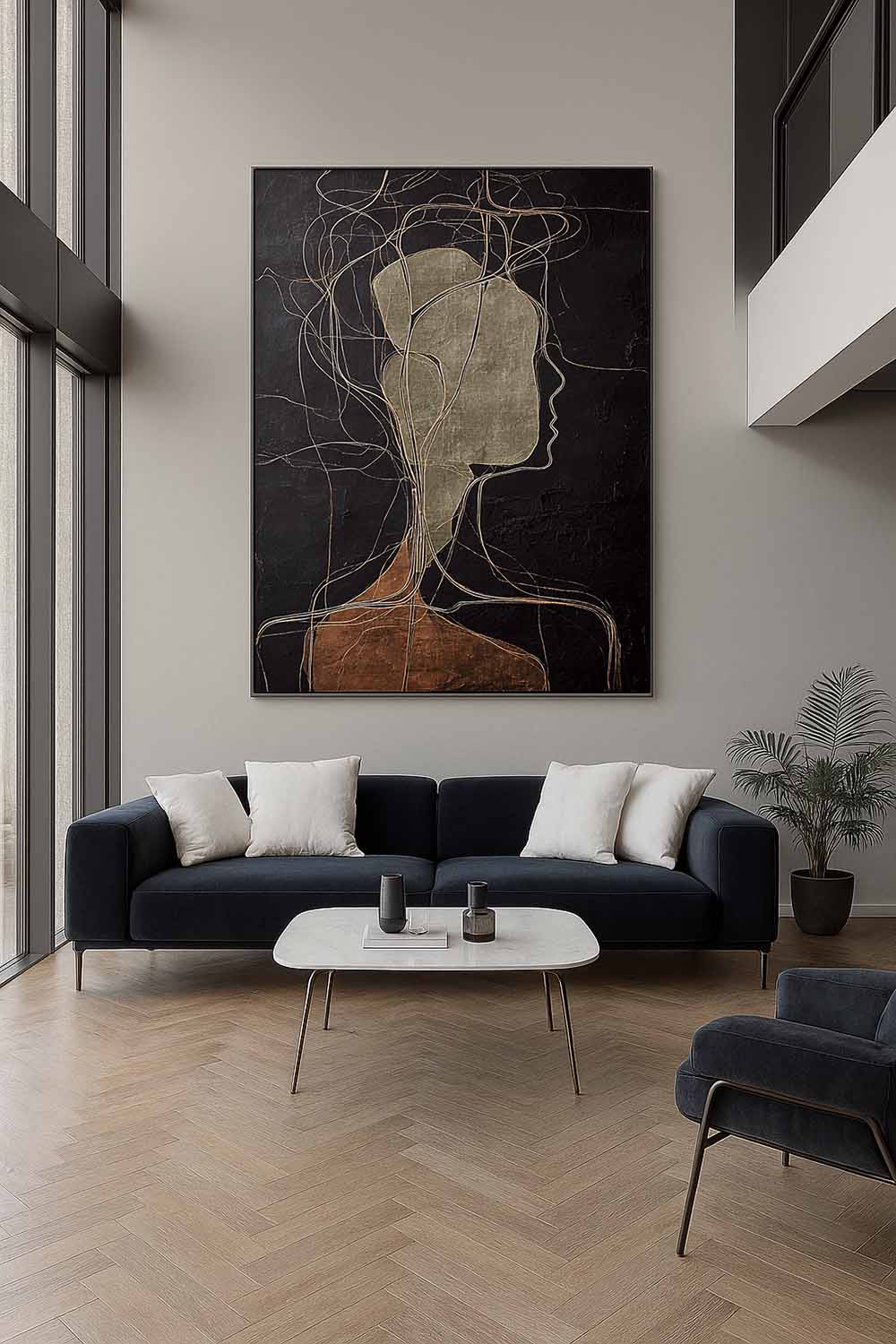 A pale abstract side profile with looping lines on black above a dark sofa